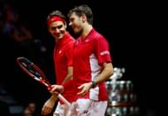 Roger Federer and Stan Wawrinka share a light moment during their doubles match at the Davis Cup Finals in 2014.